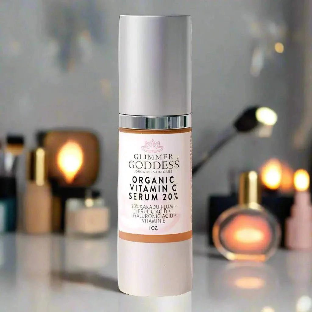 Bottle of Glimmer Goddess Organic Vitamin C Face Serum 20% with Hyaluronic Acid and Ferulic Acid on blurred vanity background