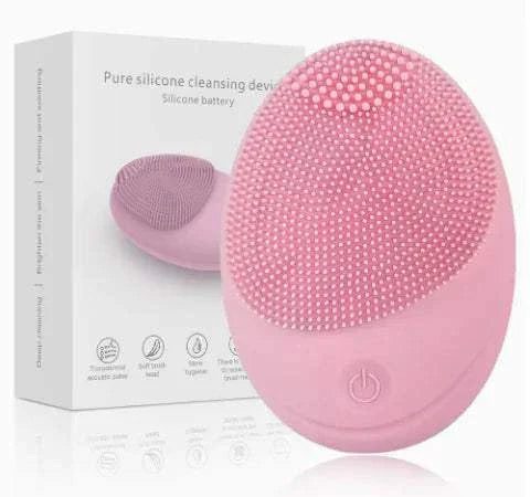 Compact pink ultrasonic plastic device for facial cleansing with silicone bristles and power button