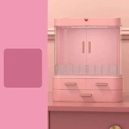 Pink plastic desktop jewelry and skincare organizer with multiple compartments and drawers for cosmetics and essentials storage