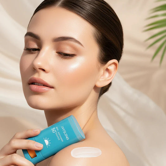 woman holding Jaysuing GlowShield SPF 50 waterproof body whitening sunscreen stick with smooth glowing skin